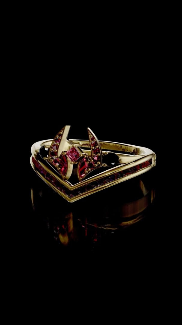 Gold anime-inspired ring with red gemstones on black