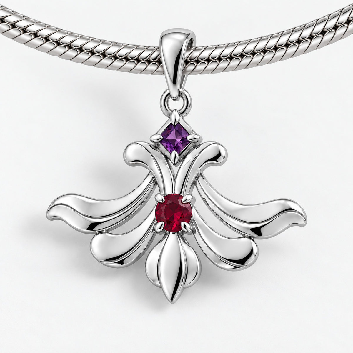 A Thousand Fashions Plume Charm in silver, on a charm bracelet