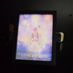 Carved wooden light panel lit from behind showing two figures under fireworks, by Kraymer Art