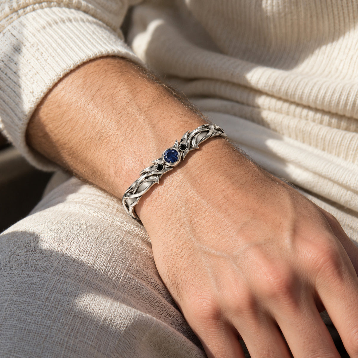 Aura Spike Cuff in silver, worn on a man's wrist