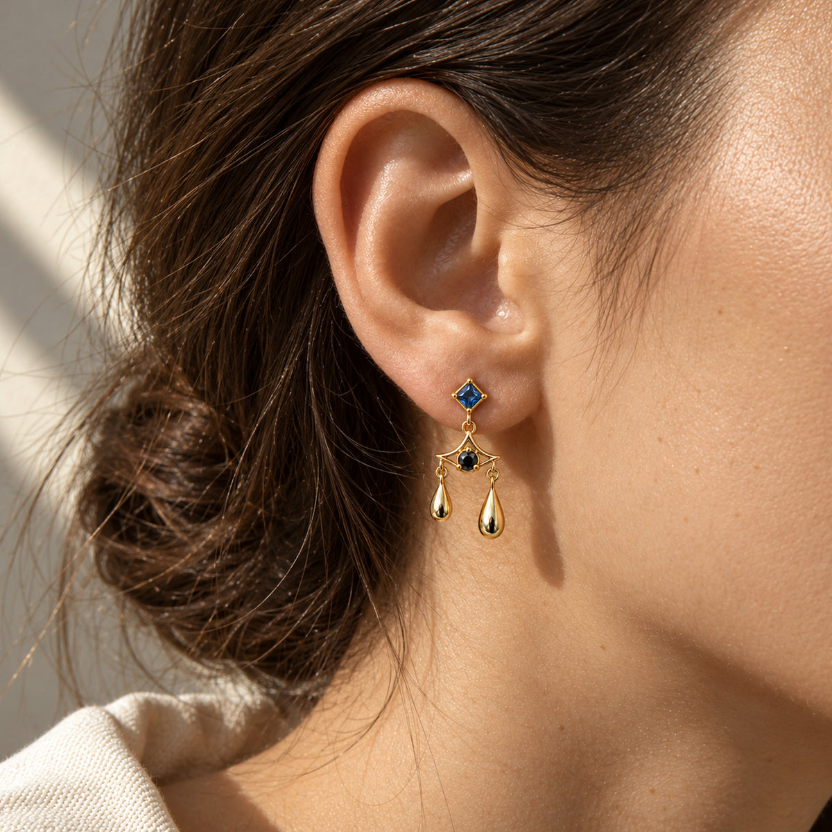 Aura Spike Earrings in gold, worn