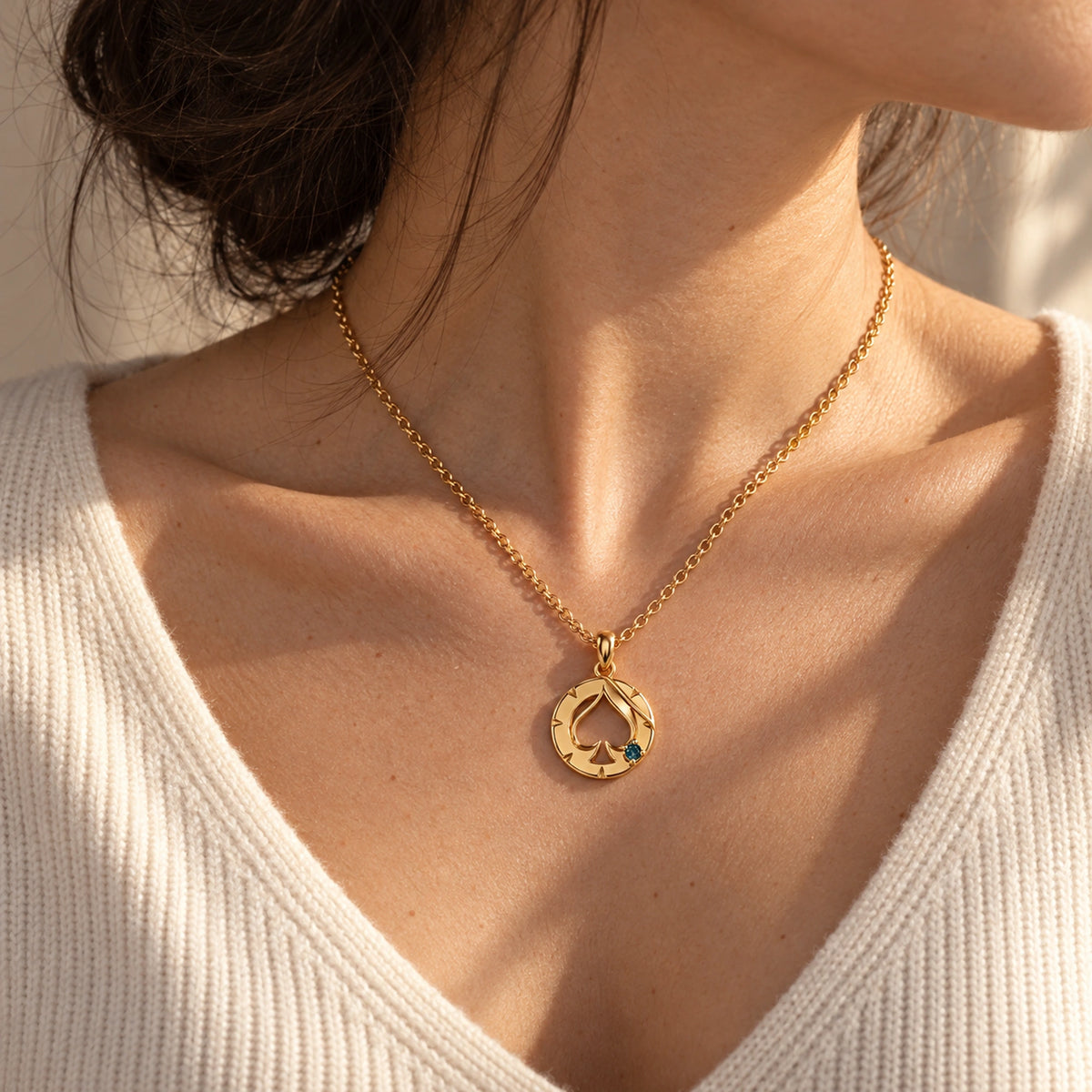 Aventurine House Medallion Necklace in gold, worn by a woman