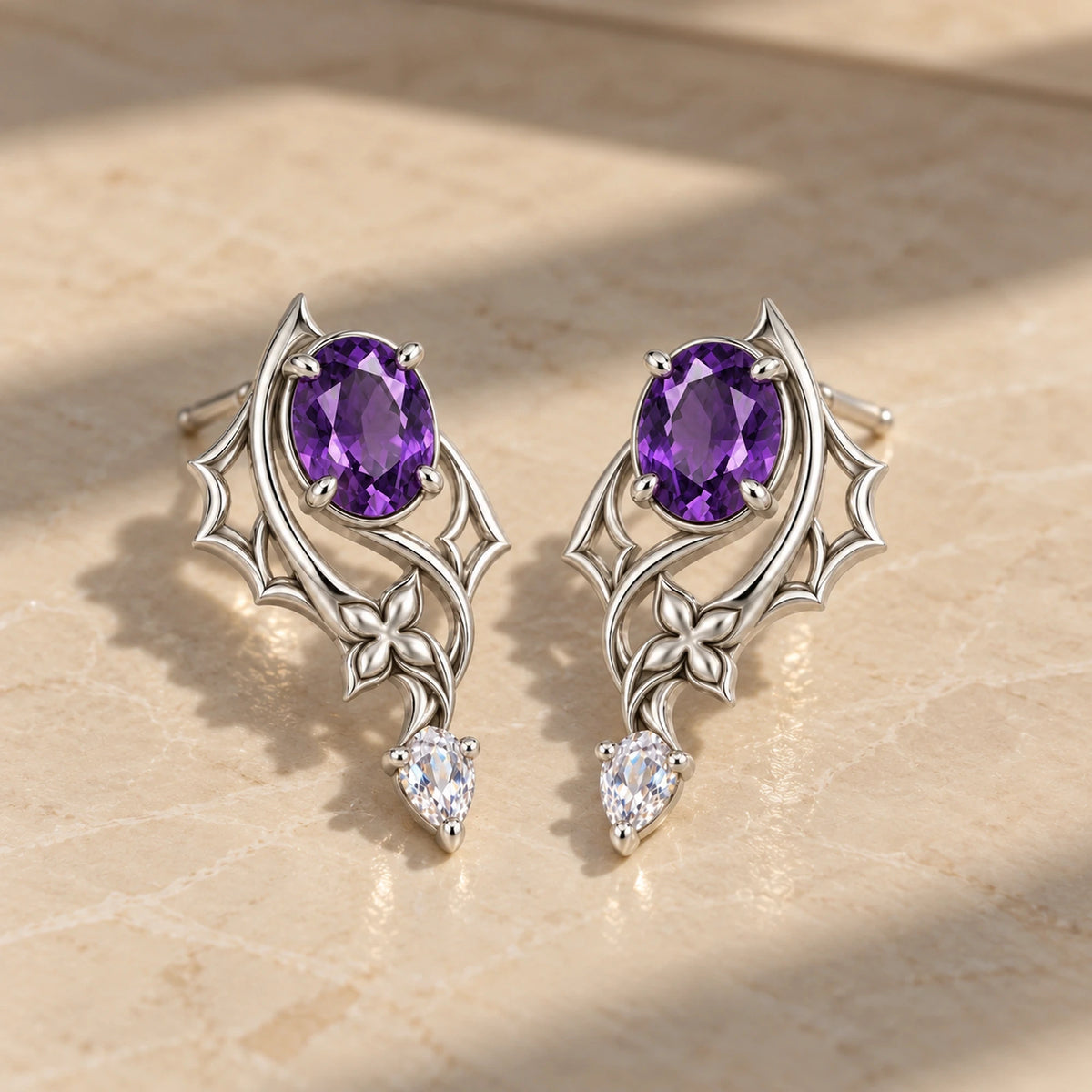 Black Swan Memoria Earrings in silver on marble in window light