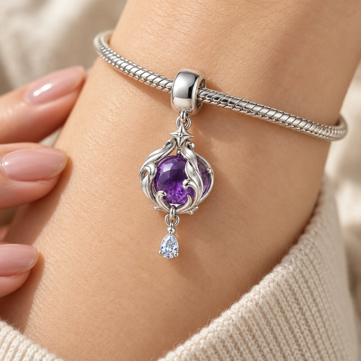 Black Swan Memory Orb Charm in silver, worn on a charm bracelet