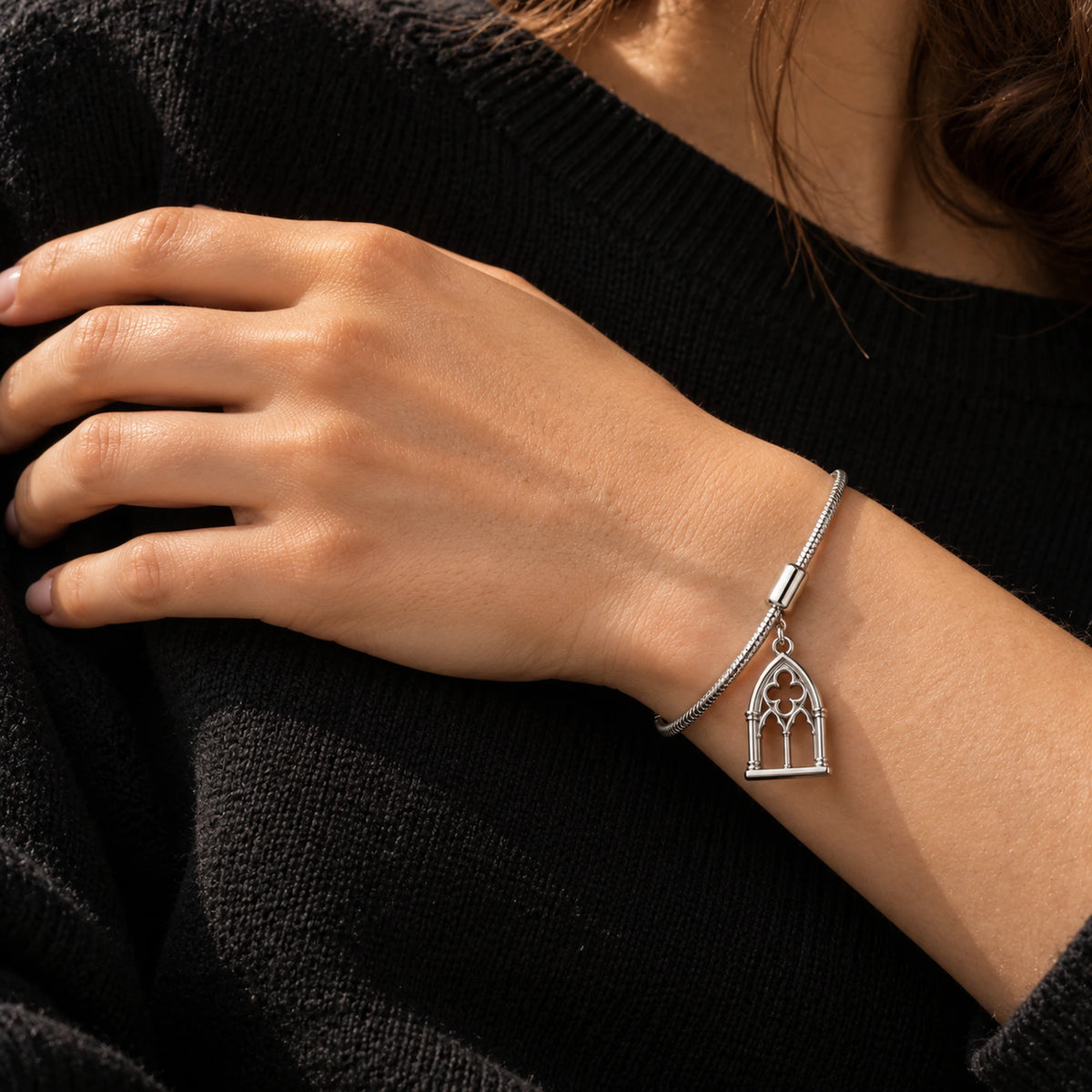 Cathedral Arch Charm in silver, worn on a charm bracelet