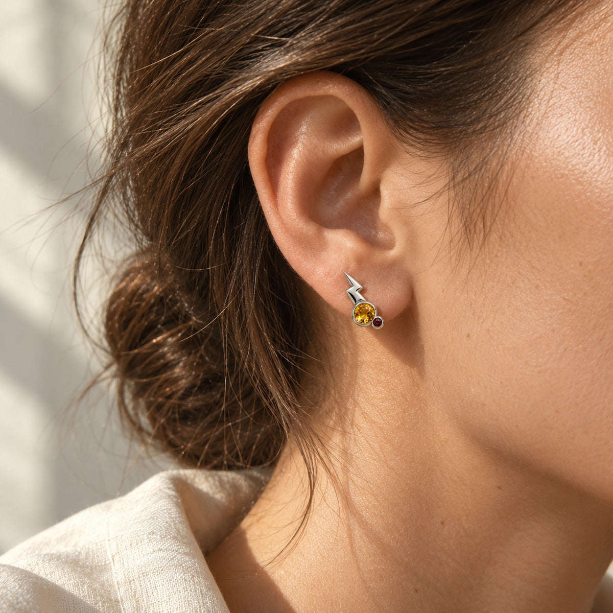 Cheek Spark Studs in silver, worn
