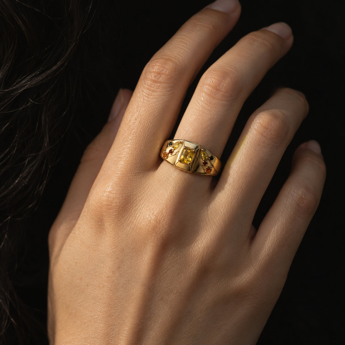 Cheek Spark Signet Ring in gold, worn