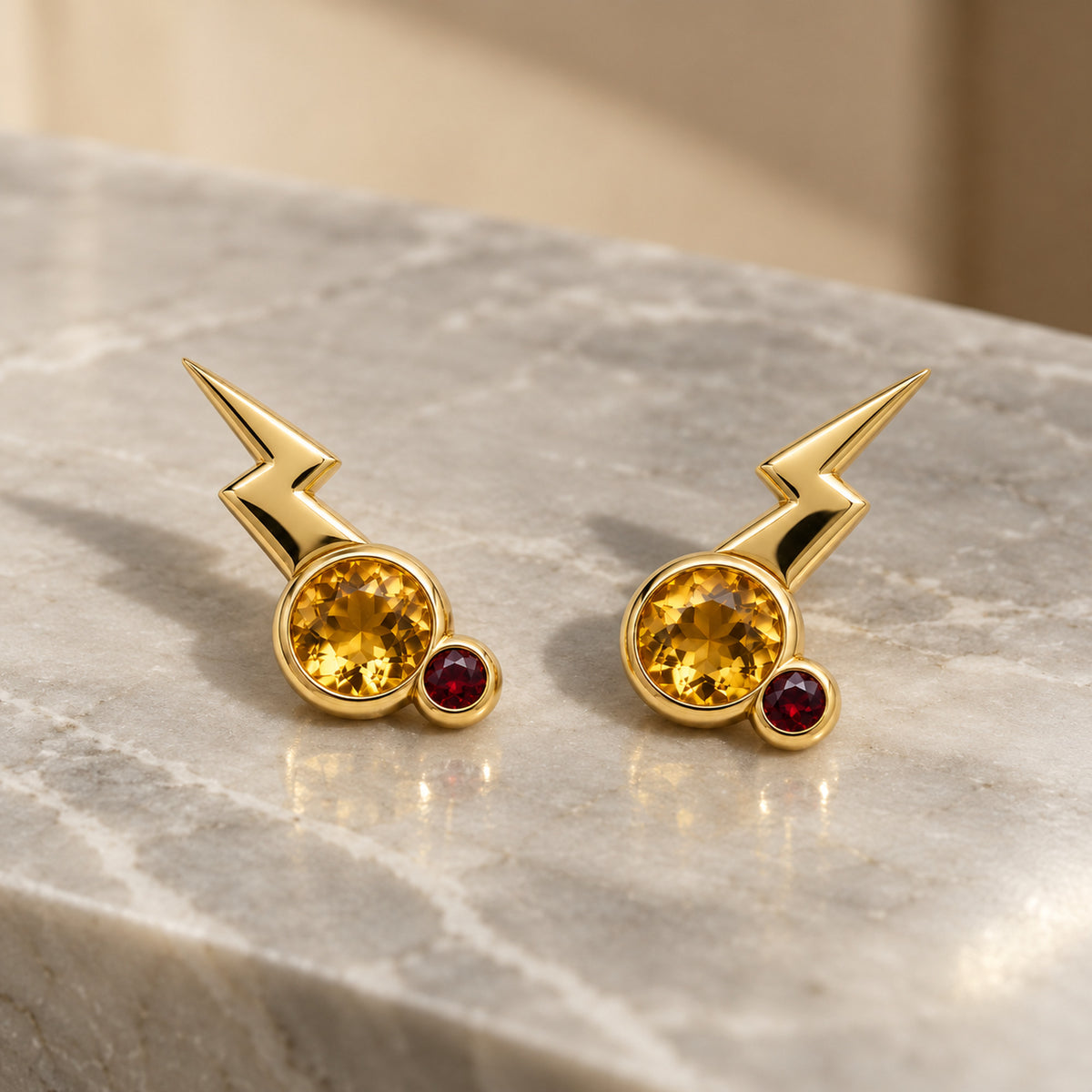 Cheek Spark Studs in gold, on marble