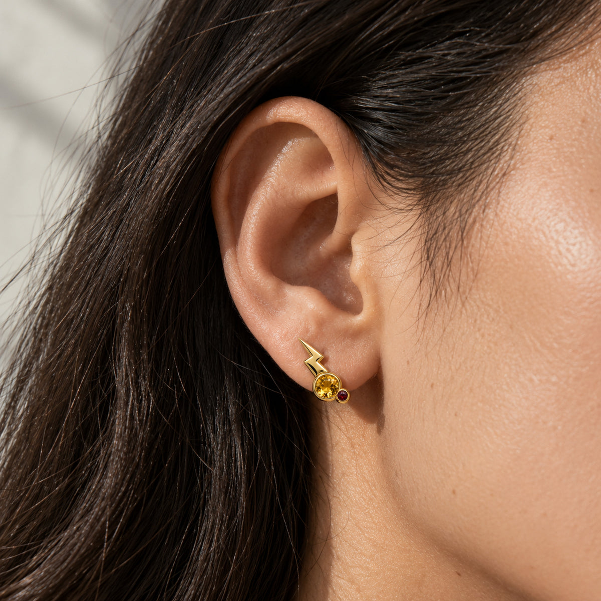 Cheek Spark Studs in gold, worn