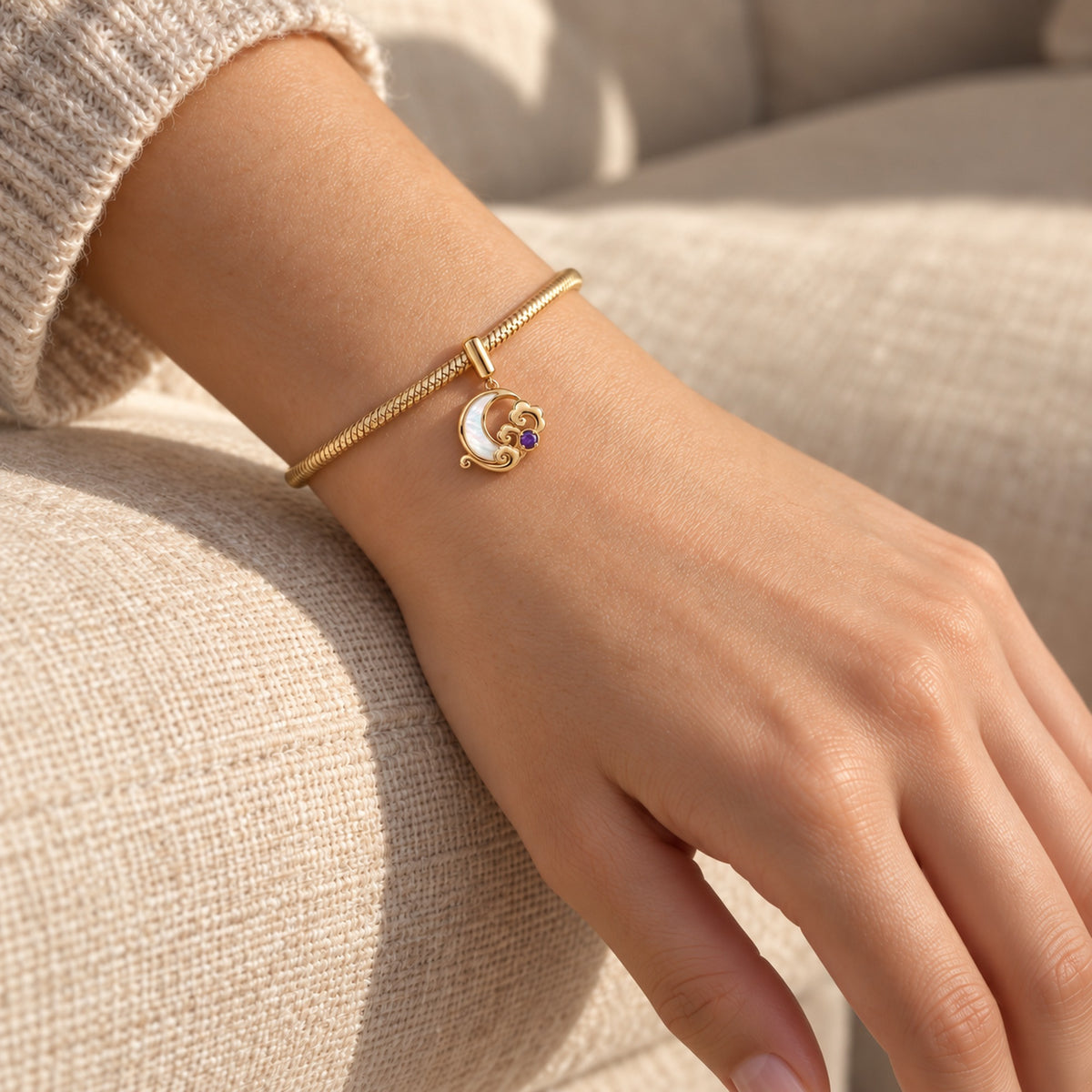 Moon Fairy Charm in gold, worn by a woman