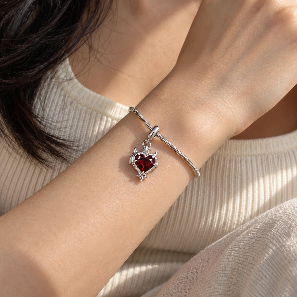 Blood Bond Heart Charm in Silver, worn on the wrist on our silver snake-chain charm bracelet
