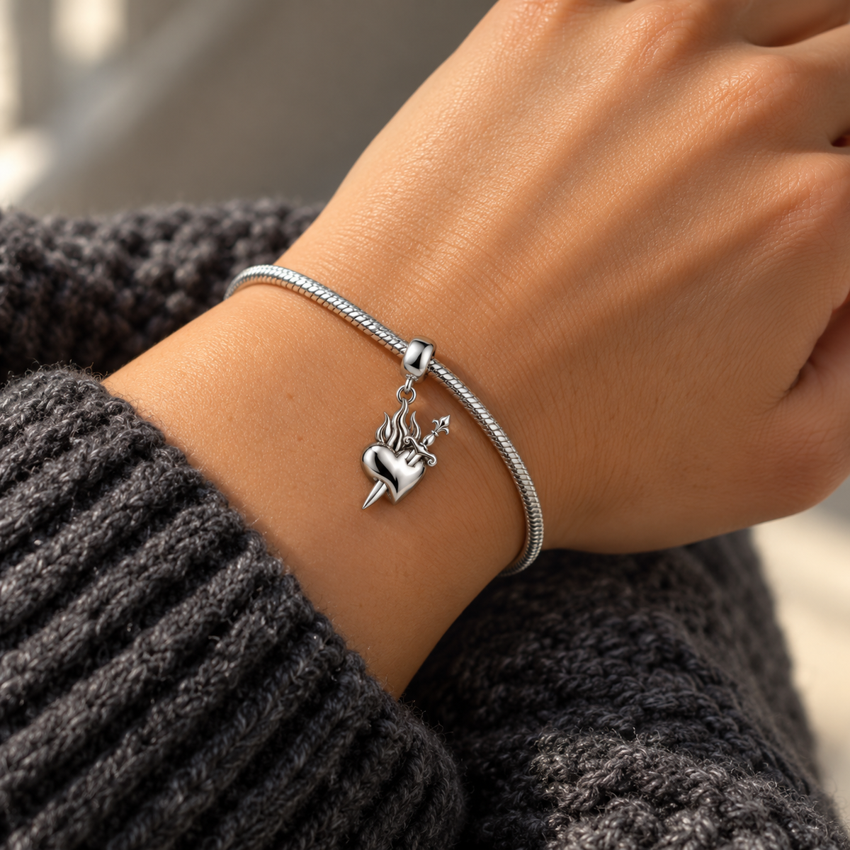Dagger Heart Charm in silver, worn on a charm bracelet
