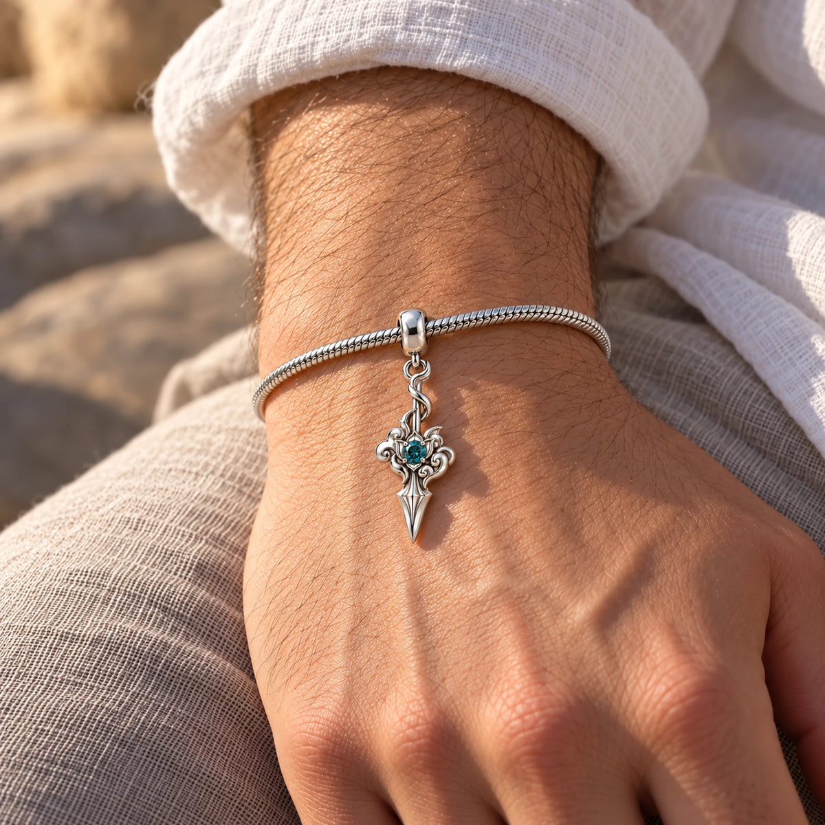 Dan Heng Cloud-Piercer Charm in silver, on a charm bracelet on a man's wrist