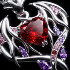 Durin Necklace macro close-up: heart-cut red gem in silver dragon-wing setting with pink and purple stones
