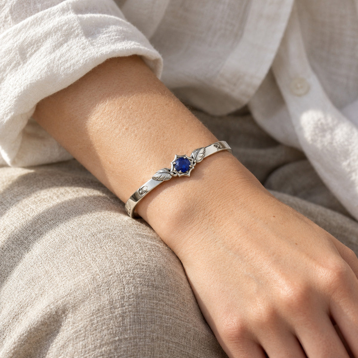 Eagle Feather Crest Bangle in silver, worn