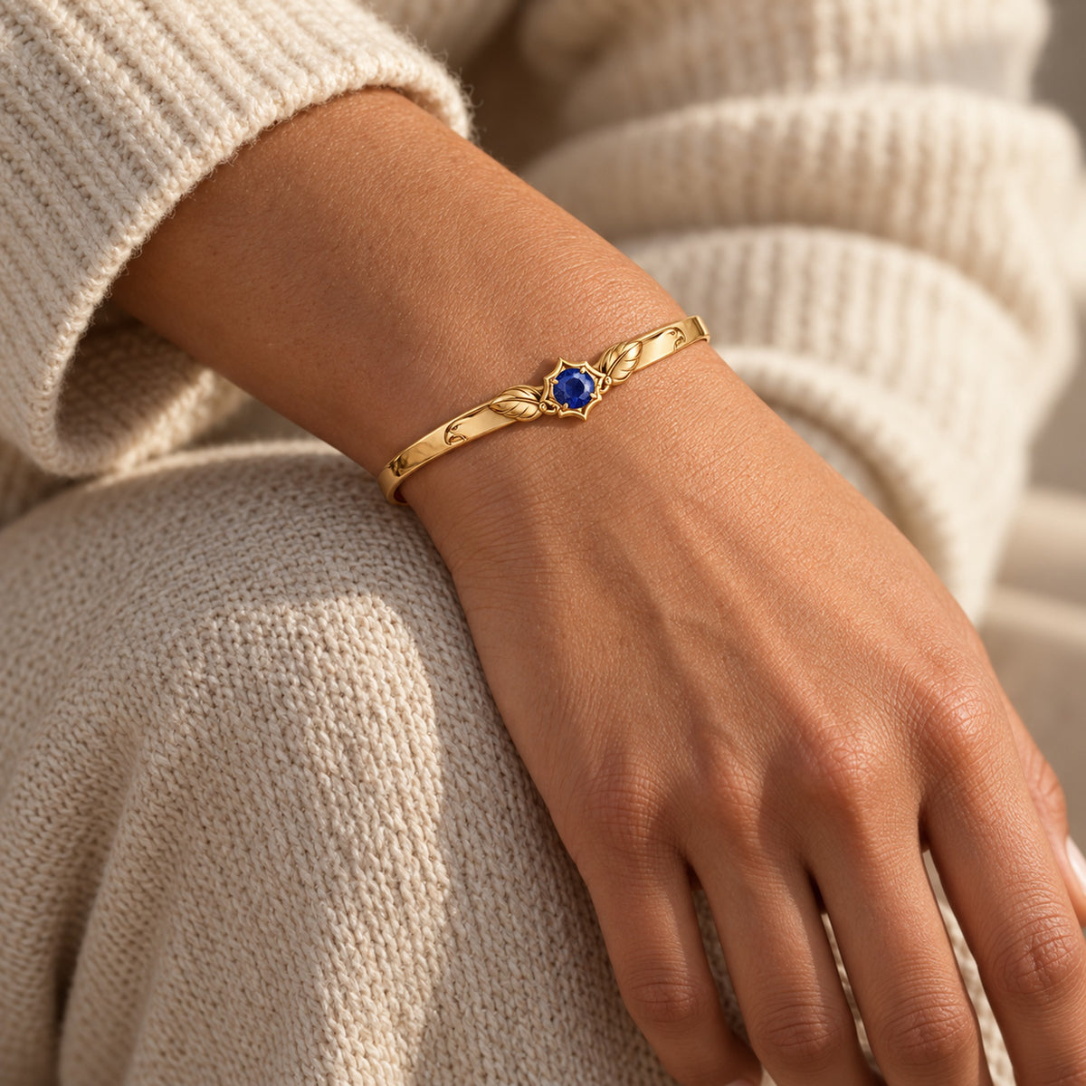 Eagle Feather Crest Bangle in gold, worn