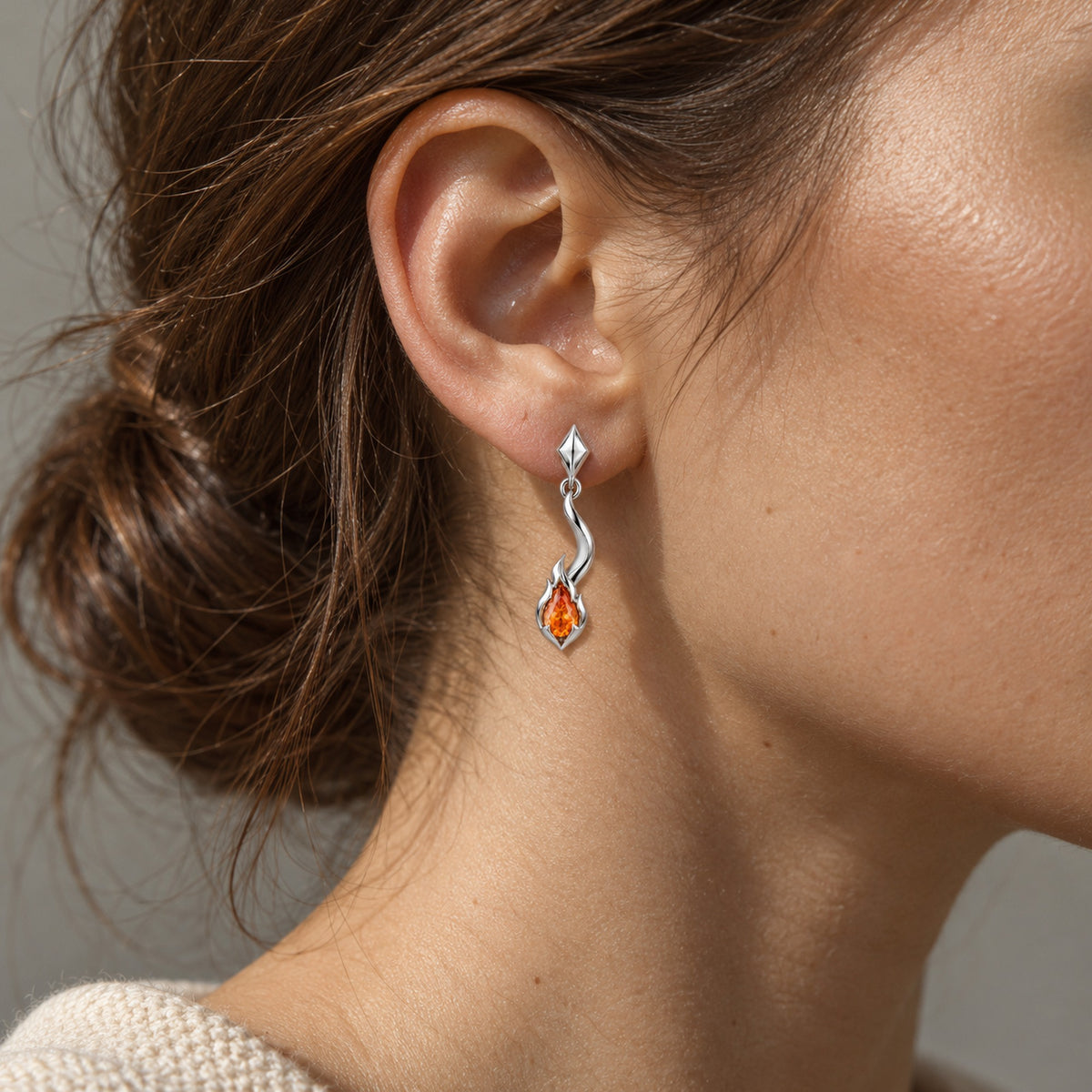 Tail Flame Earrings in silver, worn