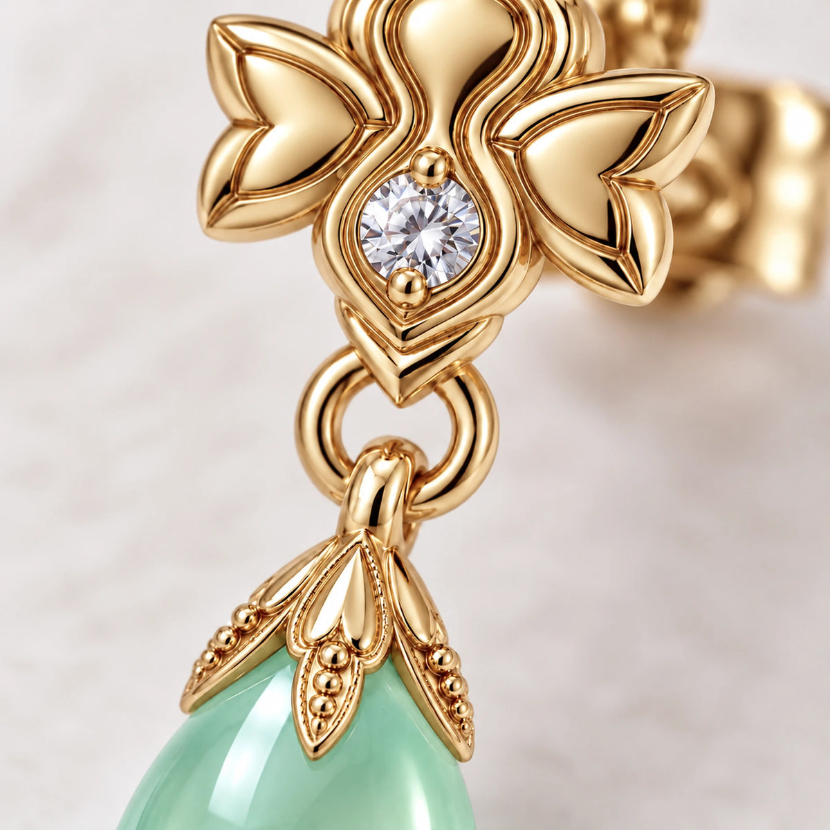 Firefly Earrings, close-up of the gold stud and mint teardrop