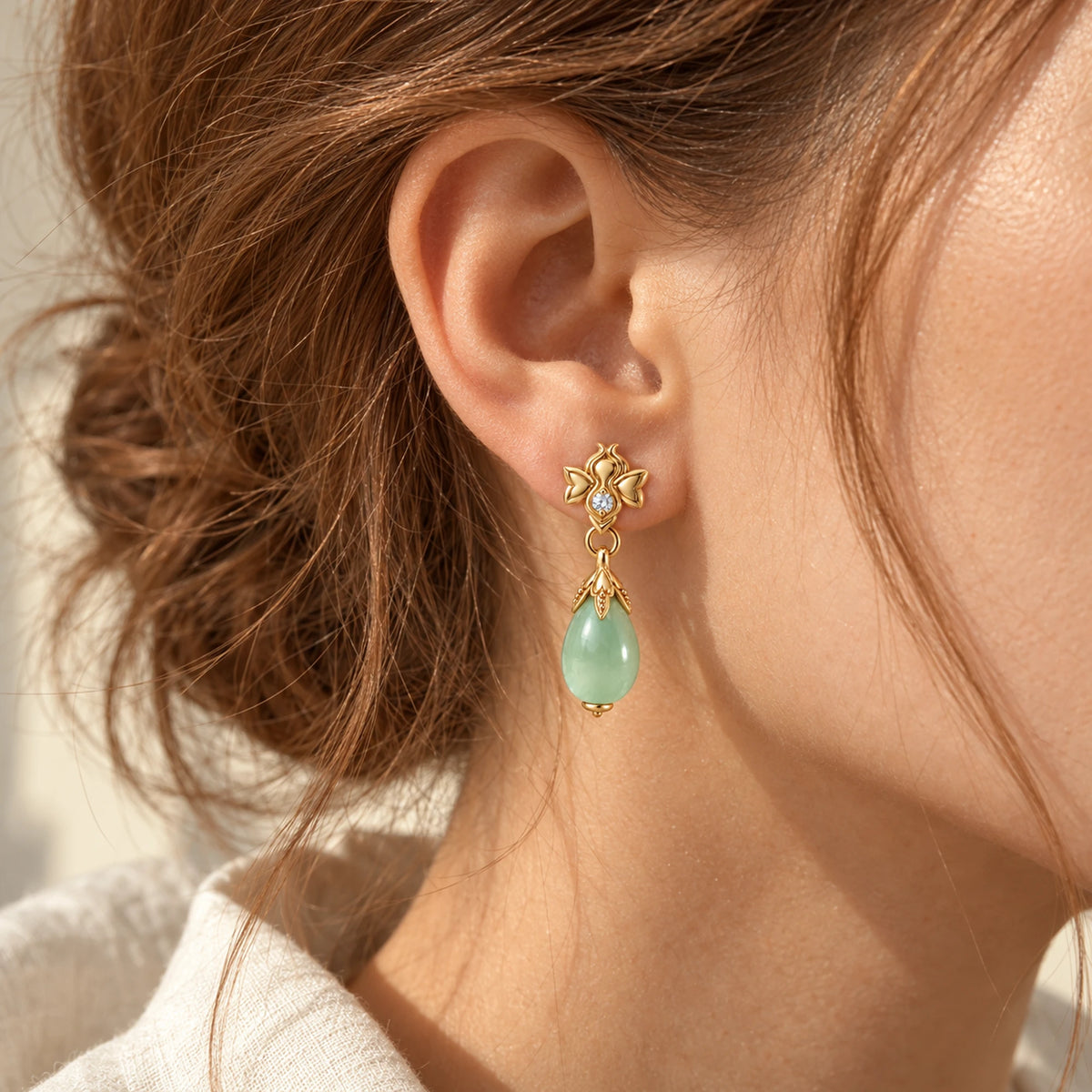 Firefly Earrings in gold, worn