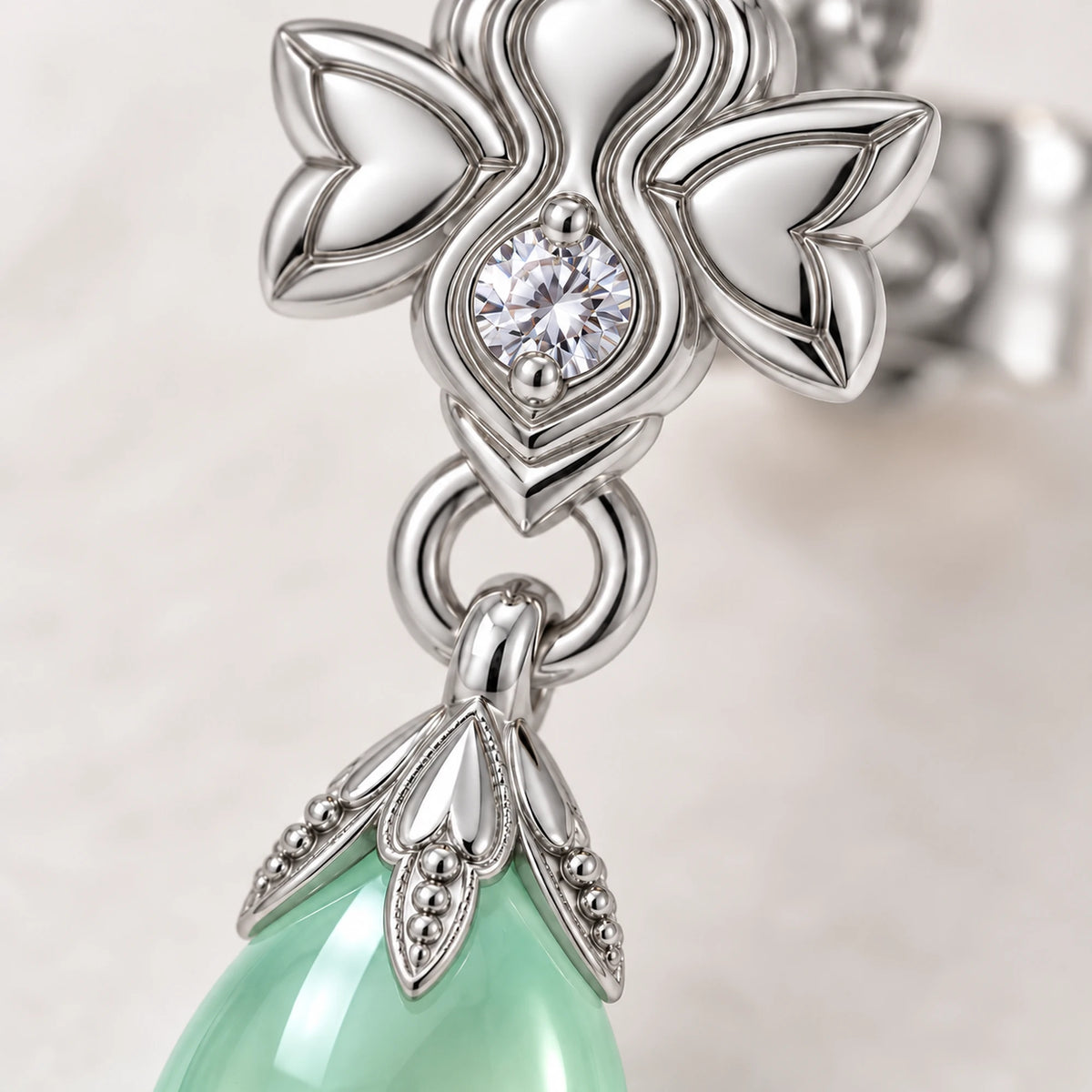 Firefly Earrings, close-up of the silver stud and mint teardrop