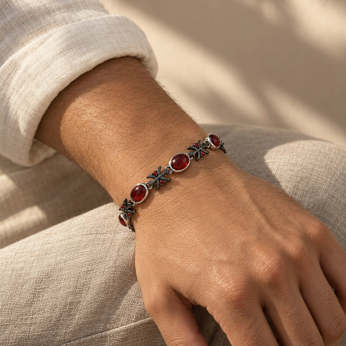 Blood Manipulation bracelet with red cabochons and cross links worn on the wrist