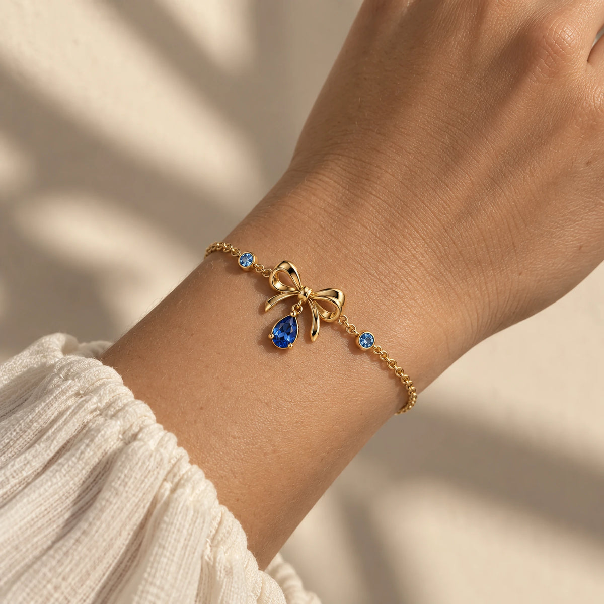 Furina Bow Bracelet in gold worn on the wrist