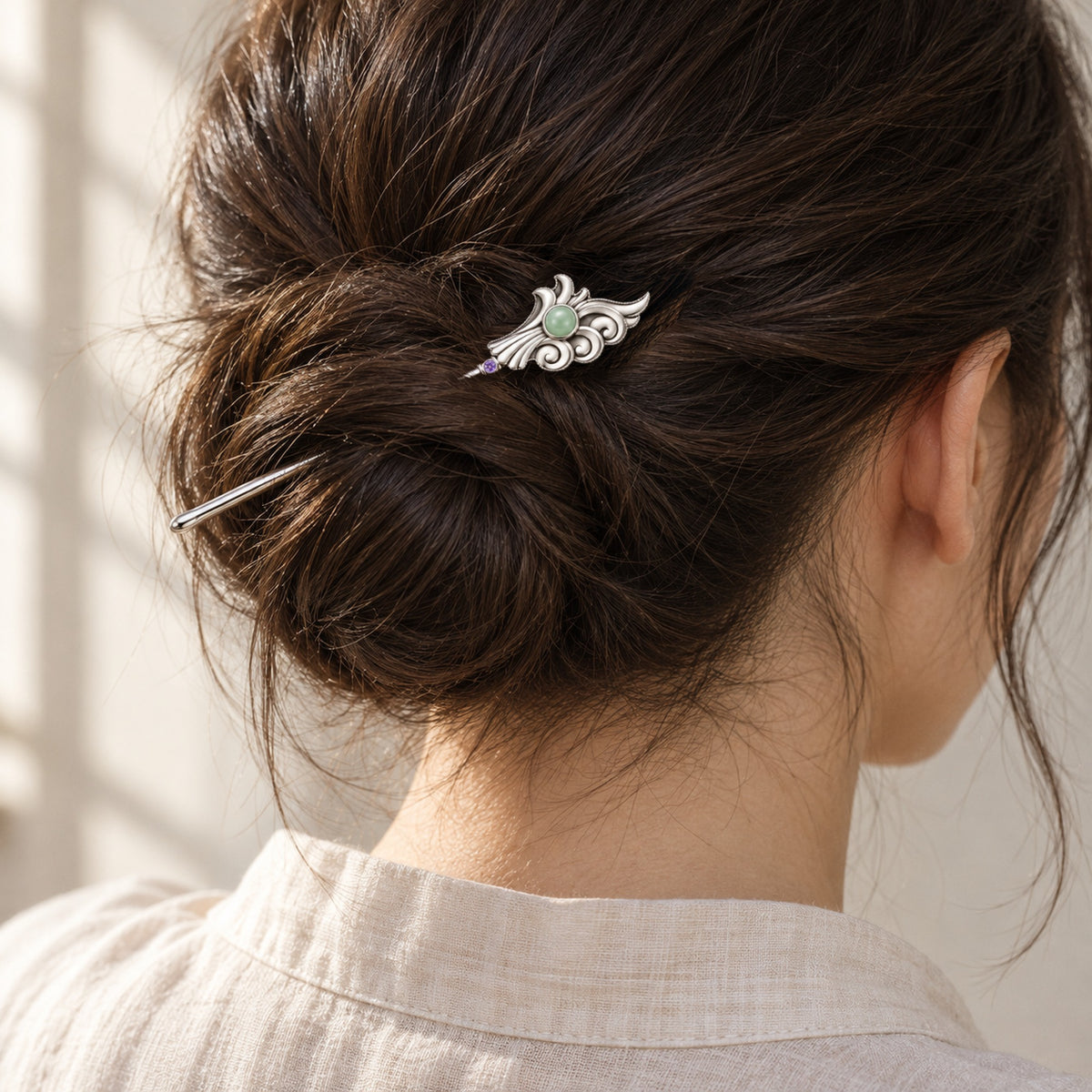 Garden Party Crest Hairpin in silver, worn as a hairpin in a low bun