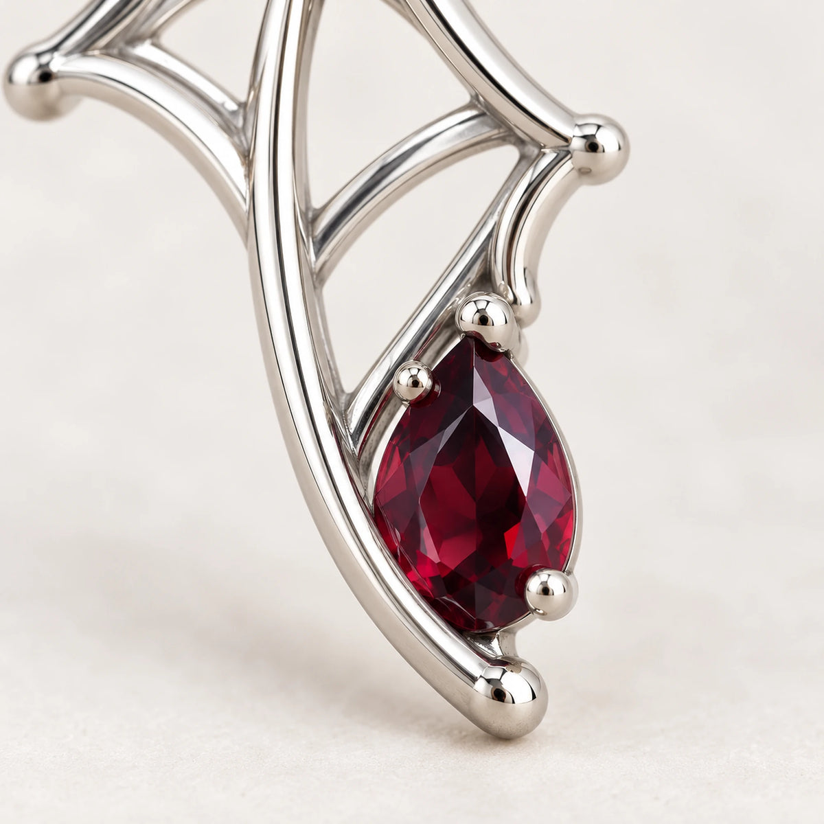 Kafka Velvet Strand Earring, close-up of the web and wine-red stone