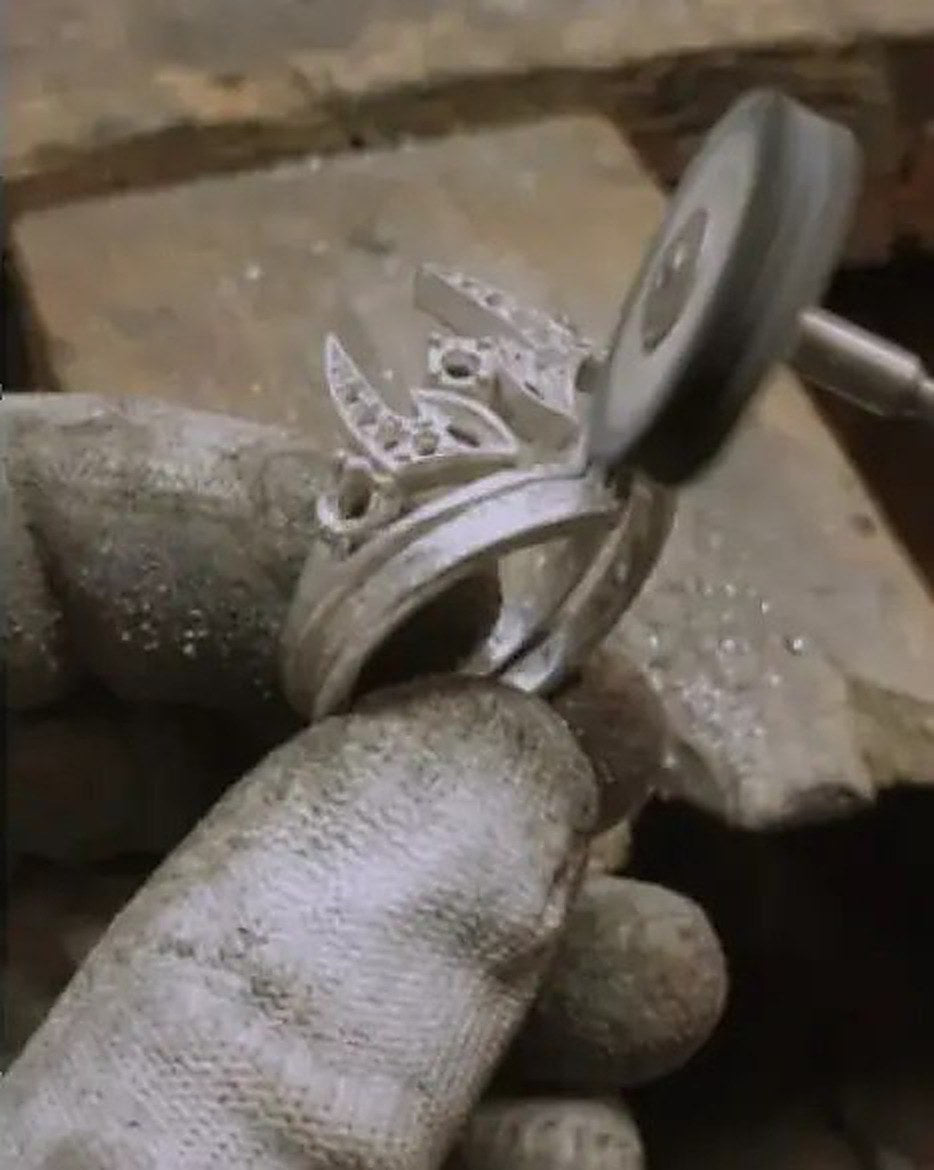 A Kraymer Art ring being polished by hand