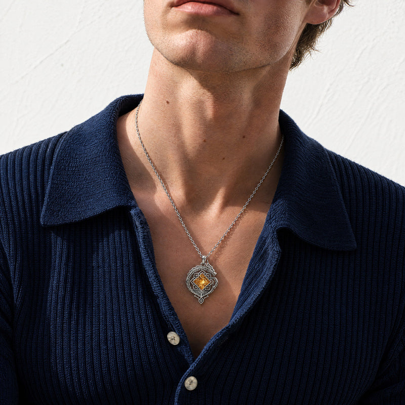 The Zhongli Necklace in silver, worn with a navy sweater