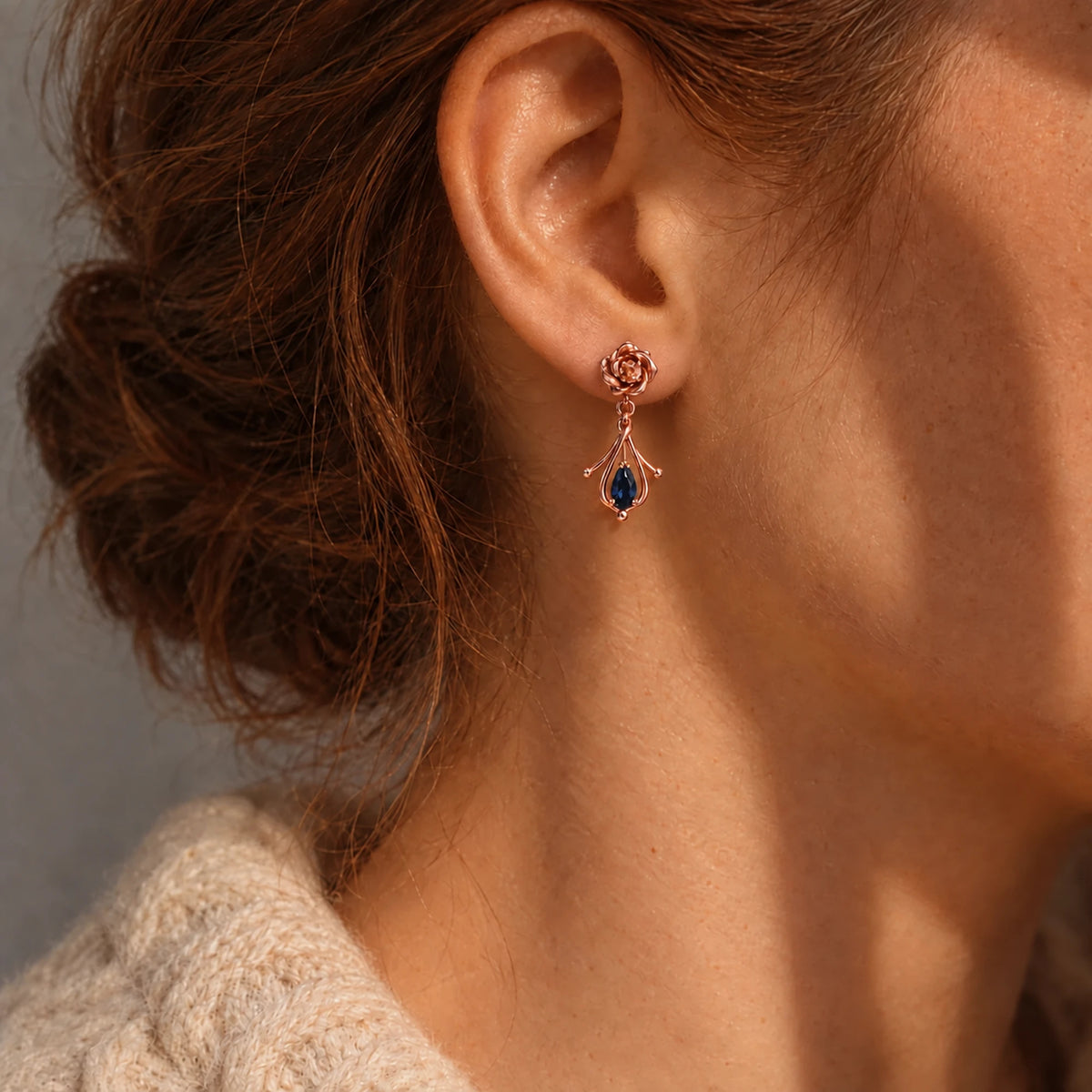 Navia Earrings in rose gold worn