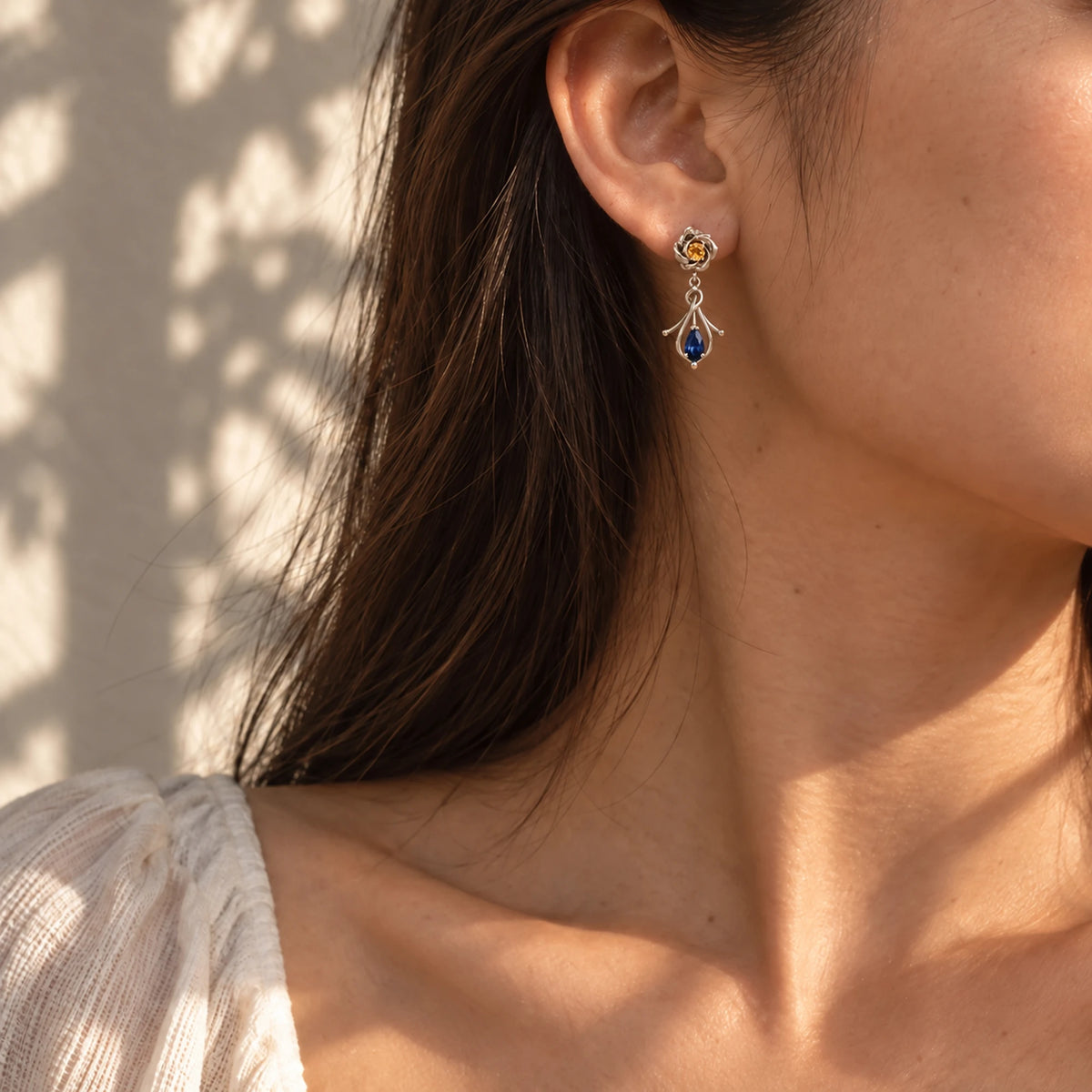 Navia Earrings in silver worn on the ear