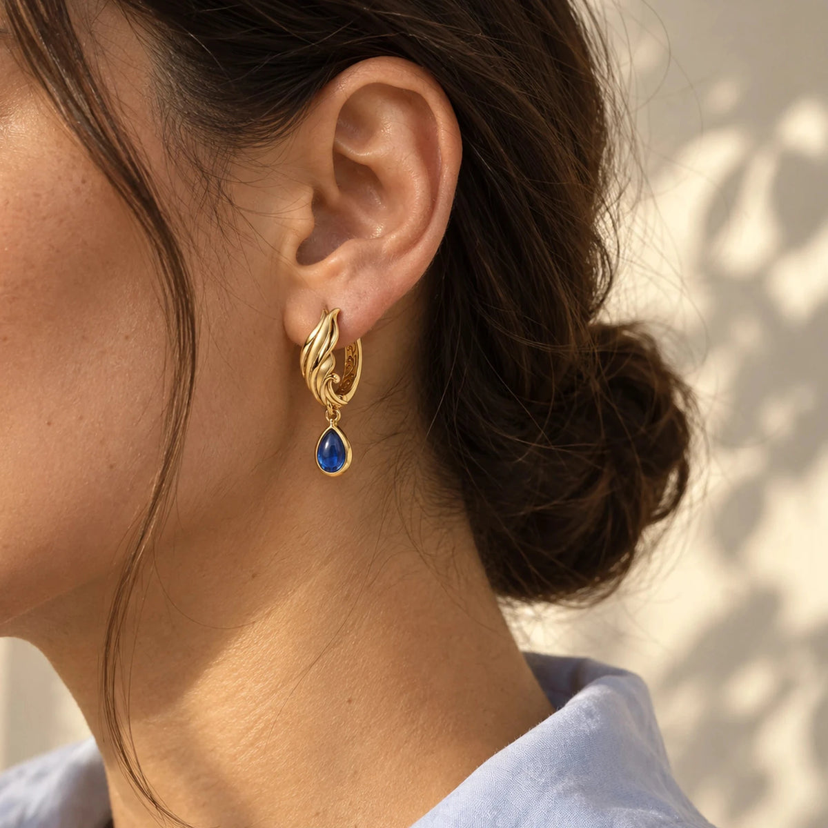 Neuvillette Earrings in gold worn on the ear