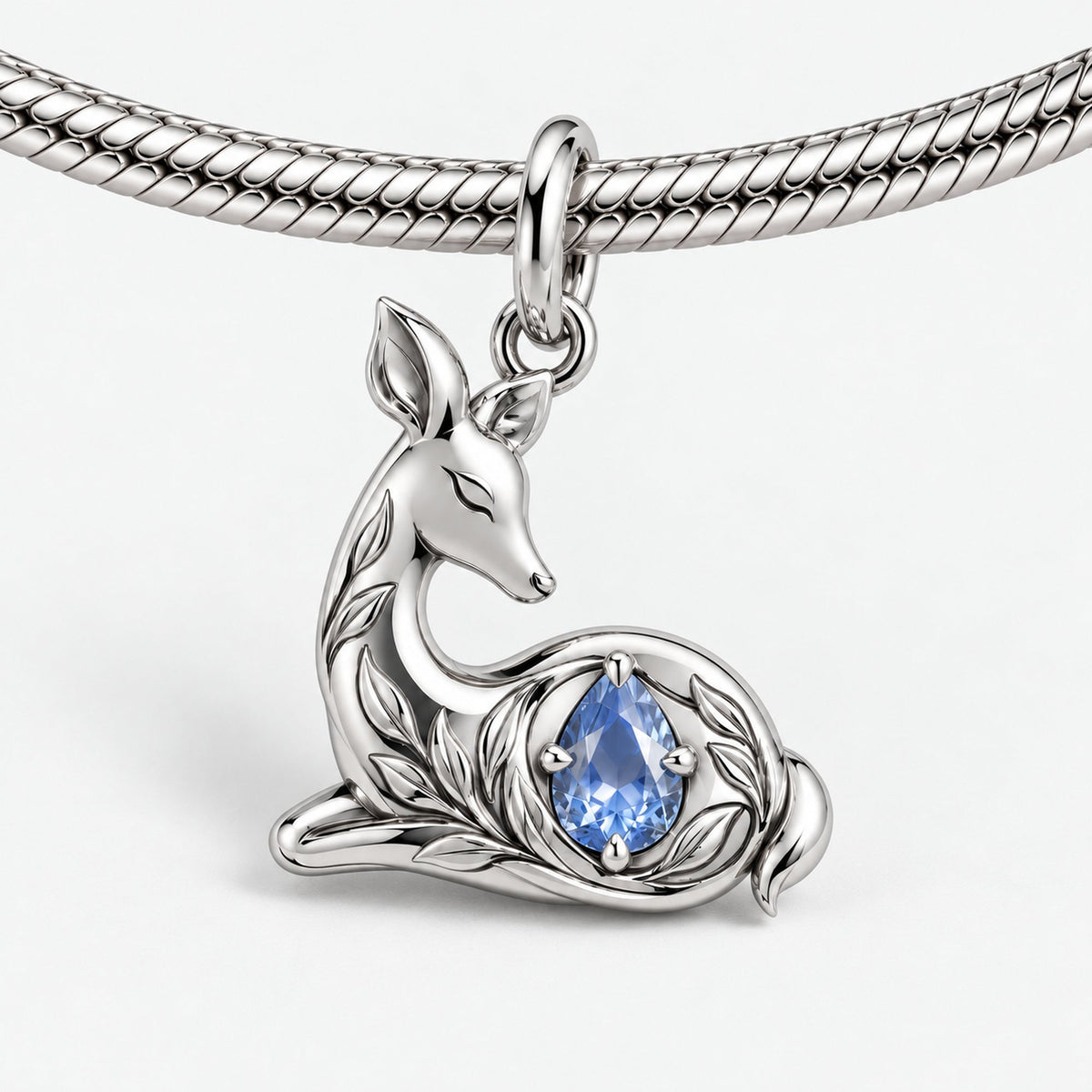 Resting Doe Pear Charm in silver, on a charm bracelet