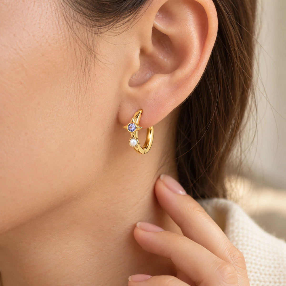 Robin Orbit Halo Huggie in gold, worn at the ear