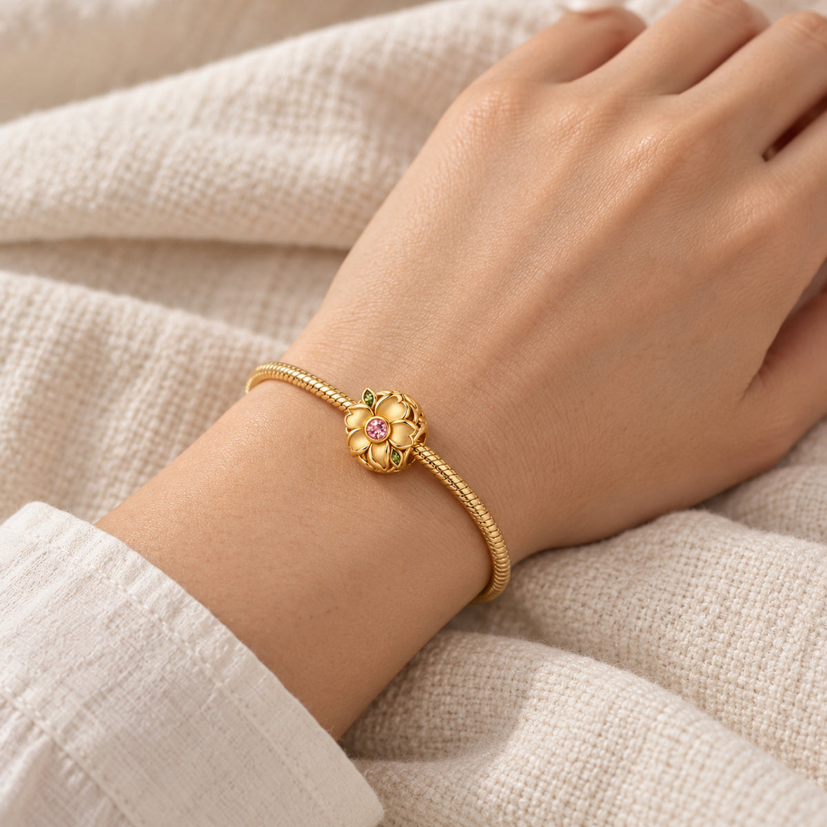 Seed Bloom Bead Charm in gold, worn