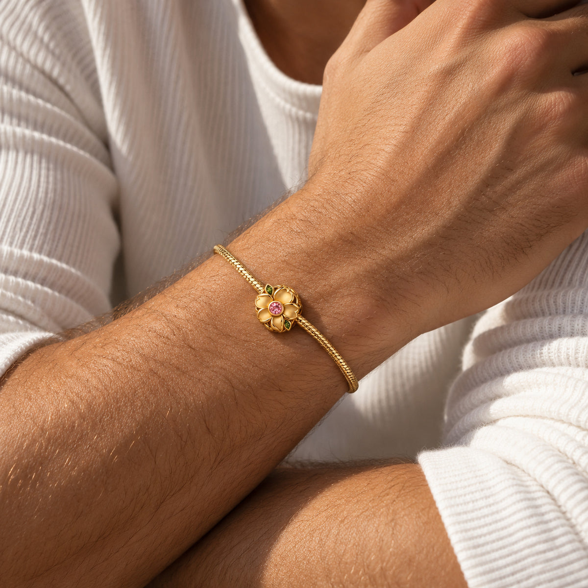 Seed Bloom Bead Charm in gold, worn on a man's wrist
