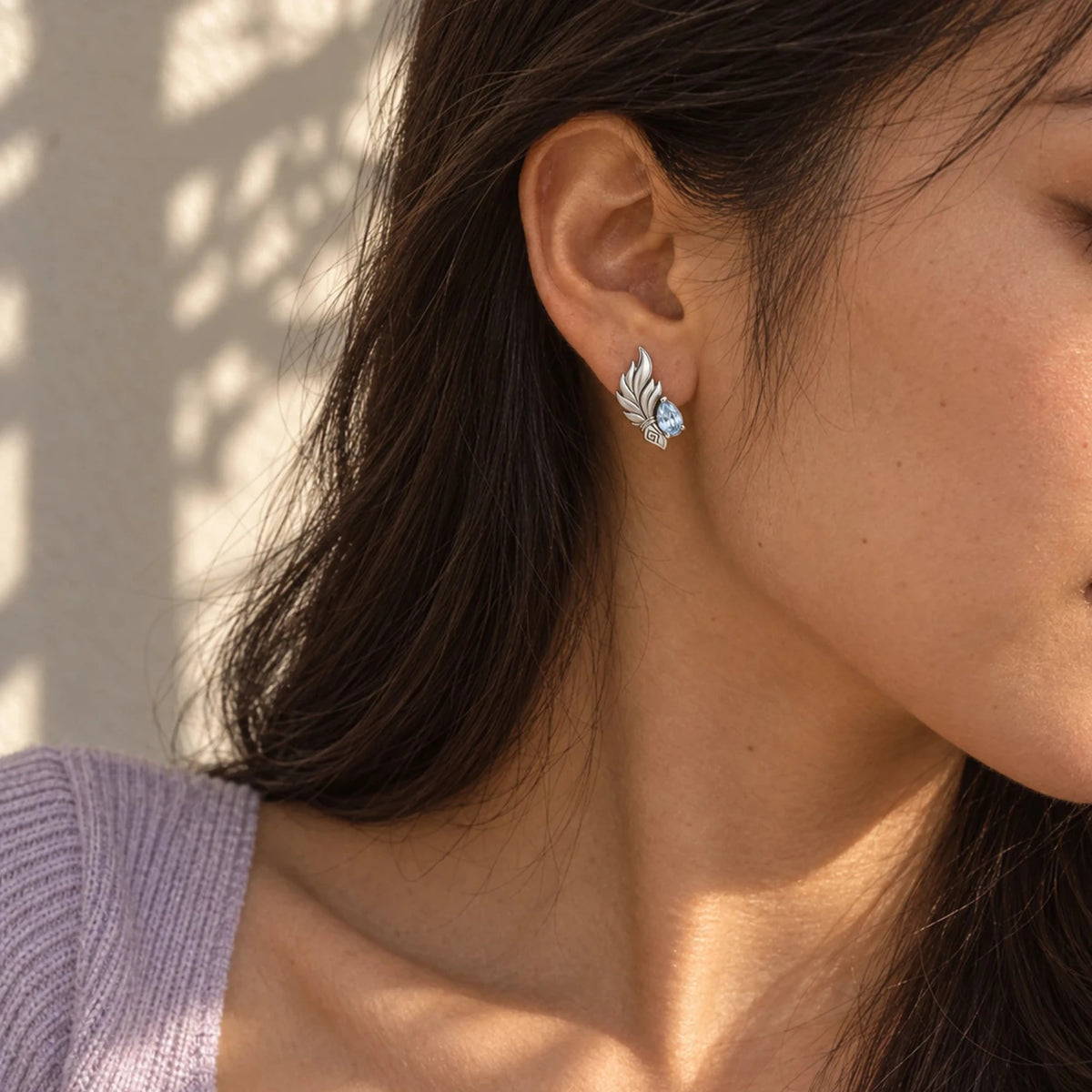 Shenhe Earrings in silver worn on the ear