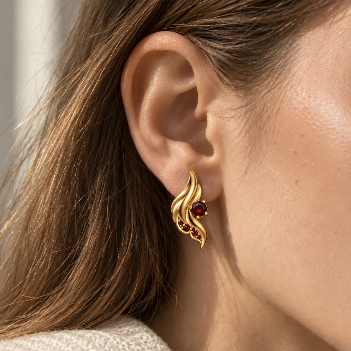 Seraph Wing Earrings in gold, worn