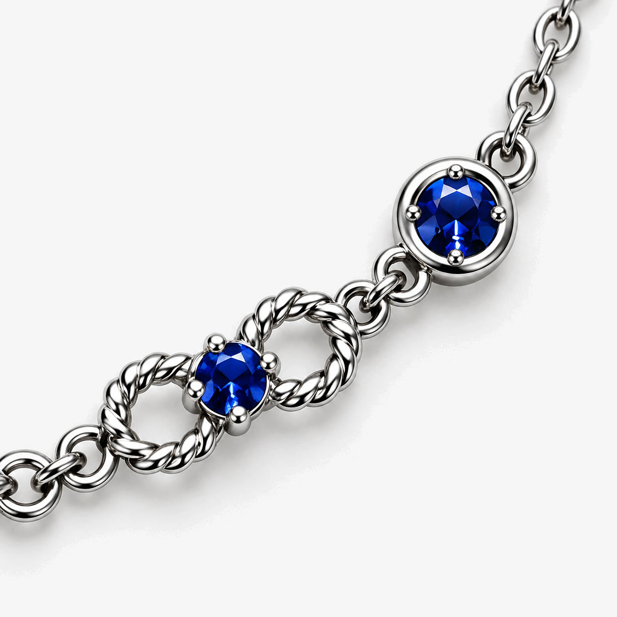 Six Eyes Infinity Necklace in silver, close-up of an infinity loop and a prong-set round stone