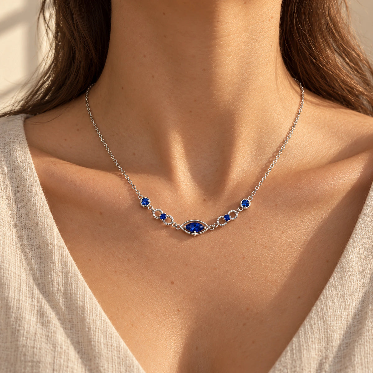 Six Eyes Infinity Necklace in silver, worn, front view; scale is illustrative