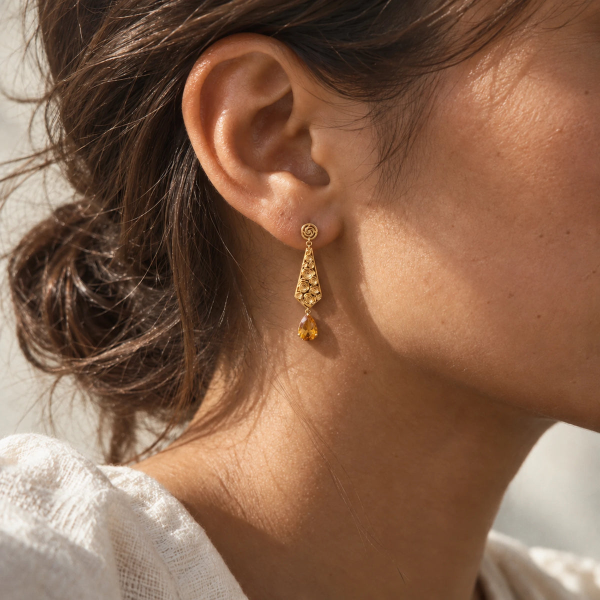 Straw Doll Earrings in gold, worn