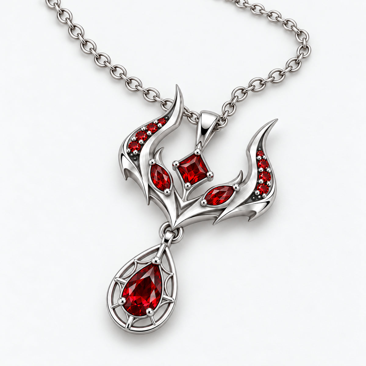 Malevolent Necklace in silver color, tabletop view of the crest and pear-shaped drop
