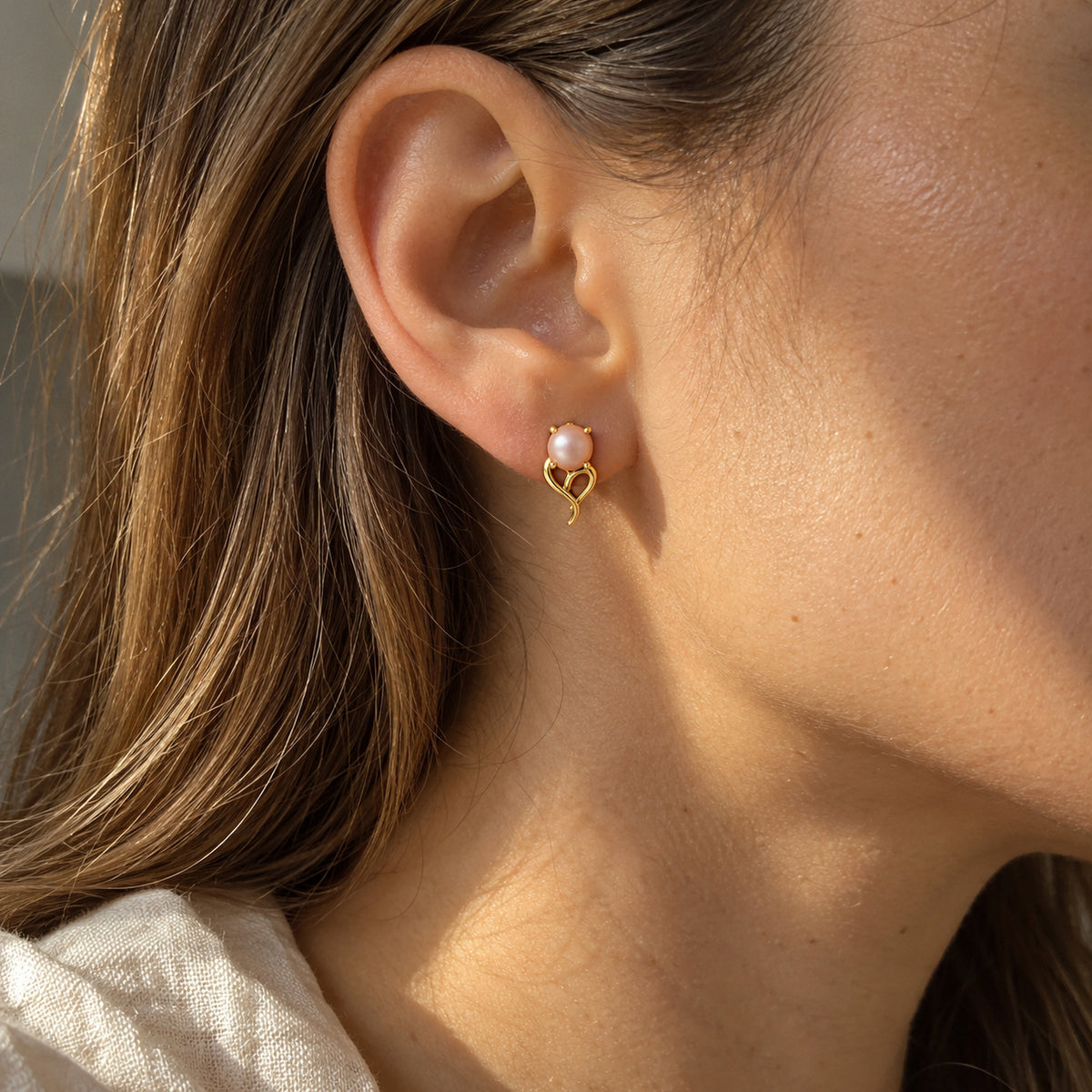 Tail Heart Studs in gold, worn