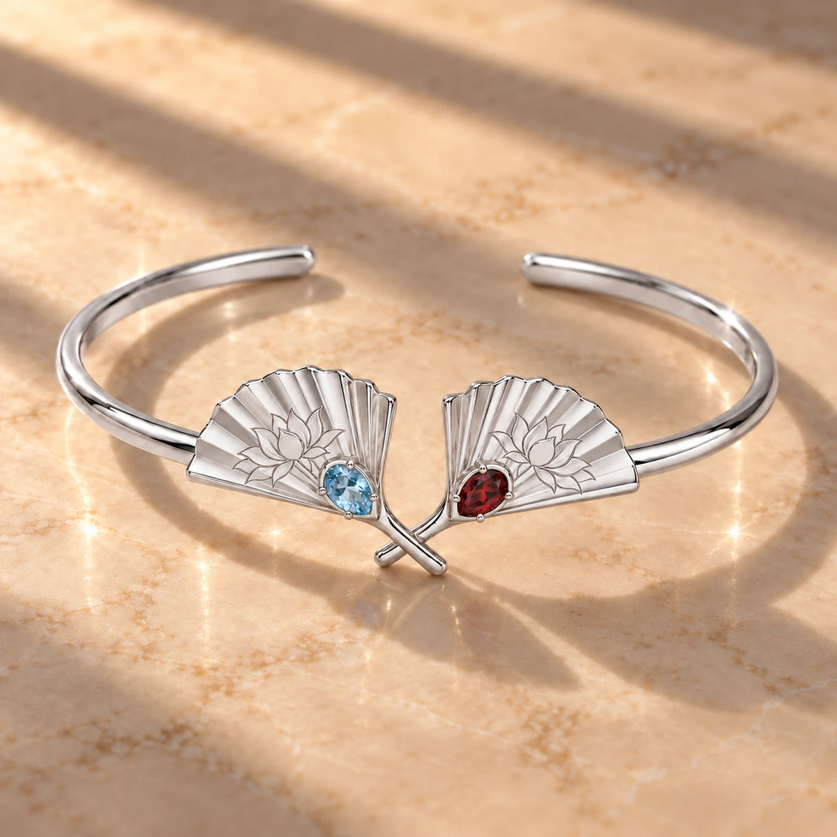 Upper Moon Two Crossed Fans Cuff in silver on marble in window light