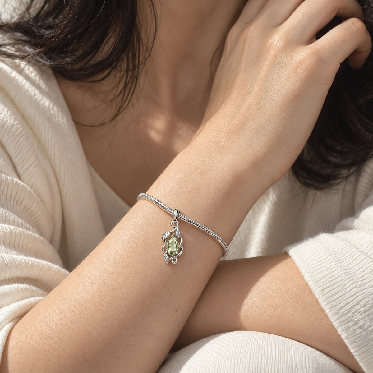 Earth Nation Vine Charm in silver, worn on a snake-chain charm bracelet