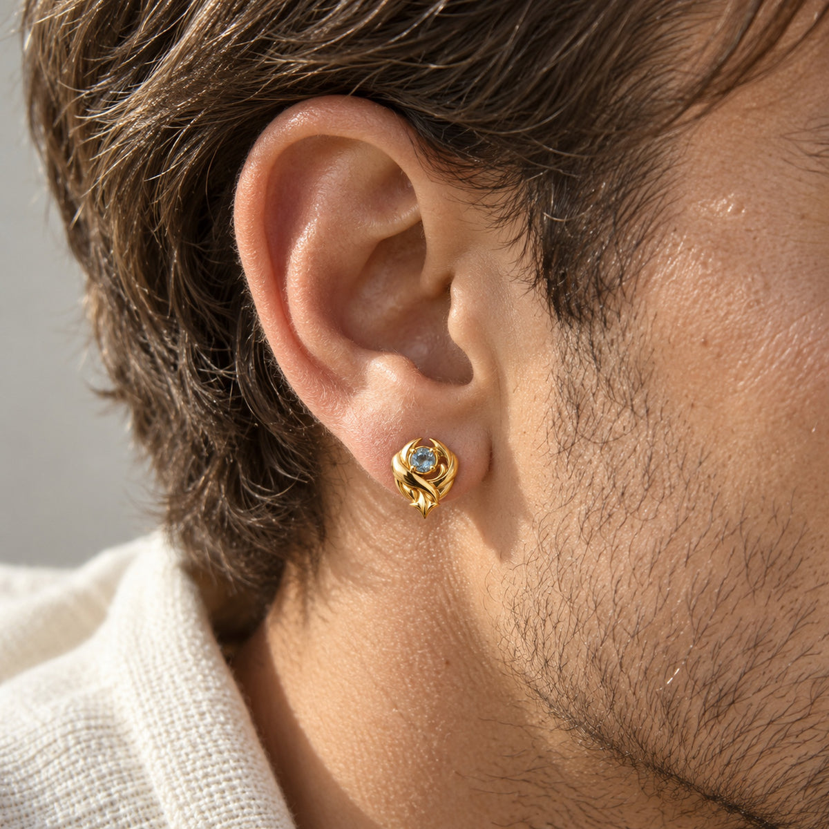 Wind Temple Earrings in gold, worn
