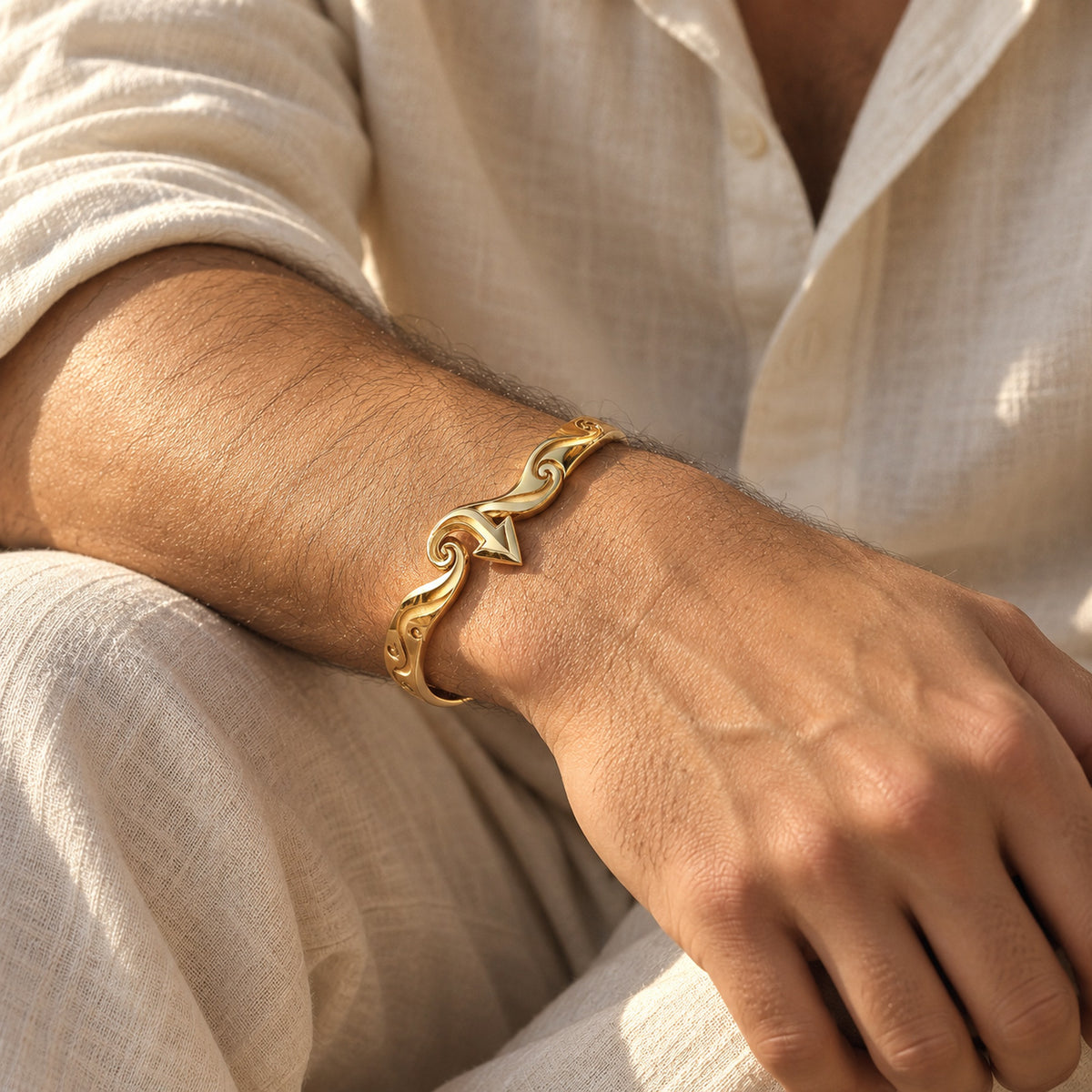 Wind Temple Arrow Cuff in gold, worn on a man