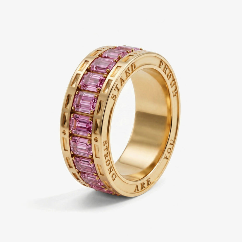 You are strong Hidden Ring in gold, standing on its edge, with STAND PROUD YOU ARE STRONG engraved around the rim